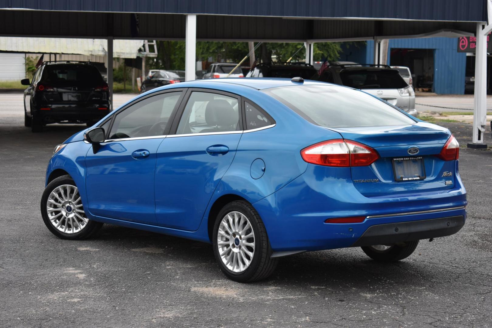 2015 BLUE Ford Fiesta Titanium Sedan (3FADP4CJ1FM) with an 1.6L L4 DOHC 16V engine, located at 420 E. Kingsbury St., Seguin, TX, 78155, (830) 401-0495, 29.581060, -97.961647 - Photo#2